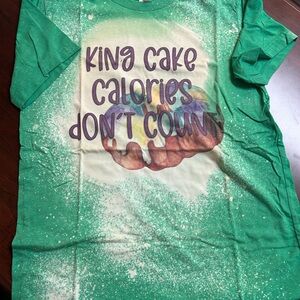 Green Graphic Tee with Fun Mardi Gras King Cake Print